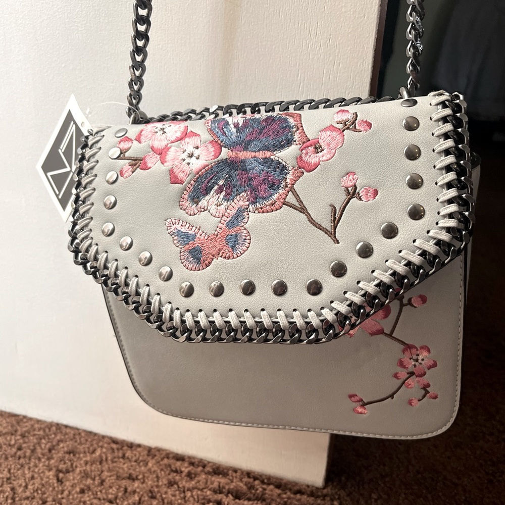 Brand new never worn butterfly and flower purse light blue :)